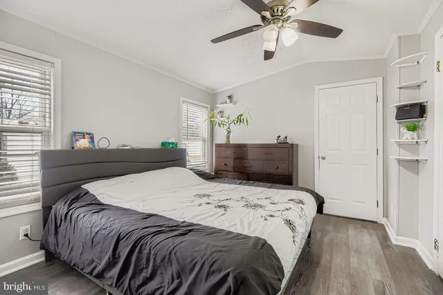 a bedroom with a bed and ceiling fan