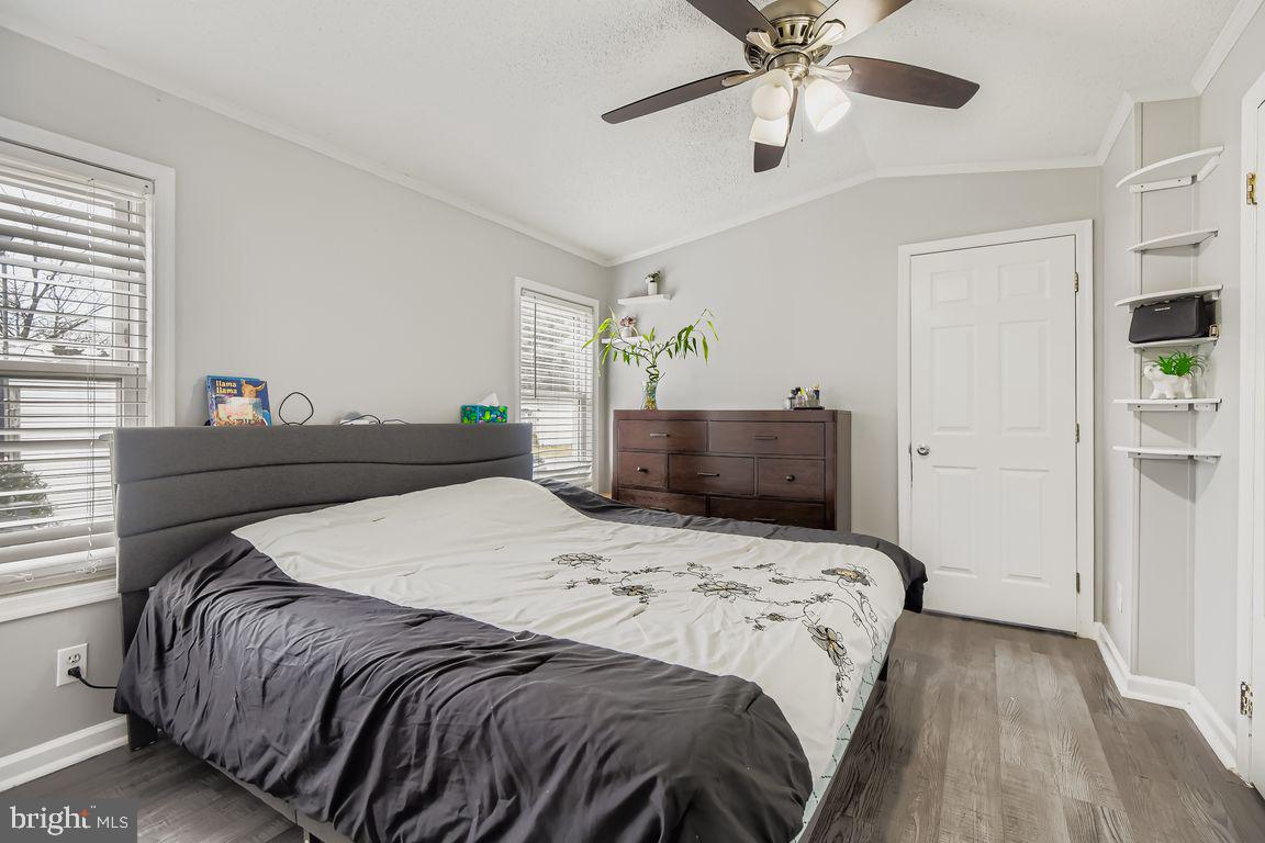 7810 Clark Road, Unit D64 Jessup, MD 20794 - Photo 11 of 28 a bedroom with a bed and ceiling fan