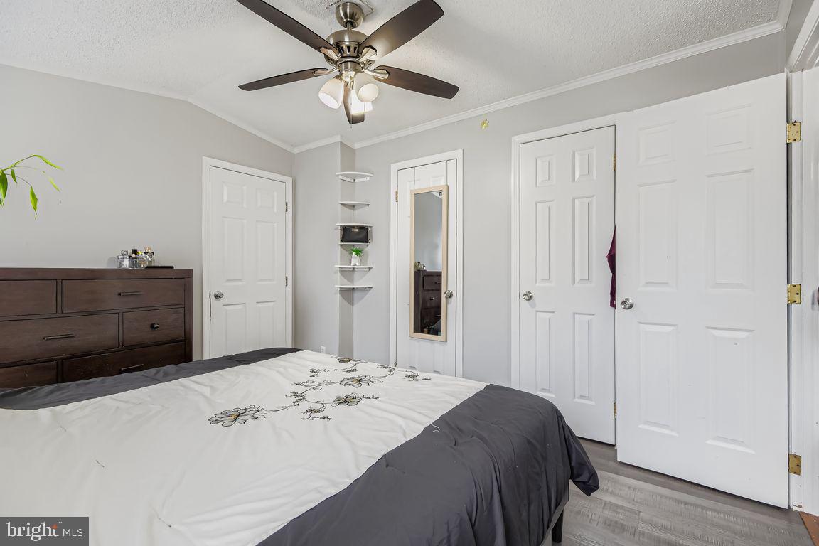7810 Clark Road, Unit D64 Jessup, MD 20794 - Photo 12 of 28 a bedroom with a bed and a chandelier
