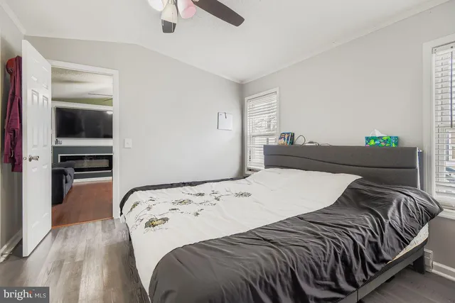 a bedroom with a bed and wooden floor