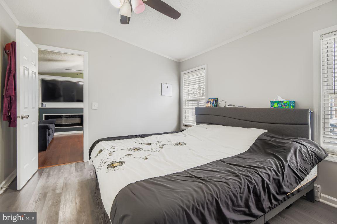 7810 Clark Road, Unit D64 Jessup, MD 20794 - Photo 13 of 28 a bedroom with a bed and wooden floor