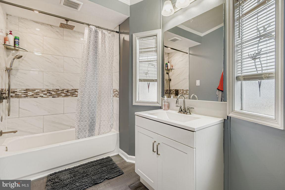7810 Clark Road, Unit D64 Jessup, MD 20794 - Photo 14 of 28 a bathroom with a sink a toilet a mirror and shower