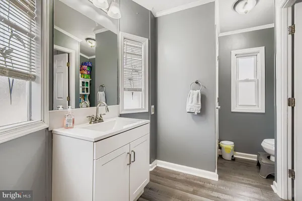 a bathroom with a sink vanity and a mirror