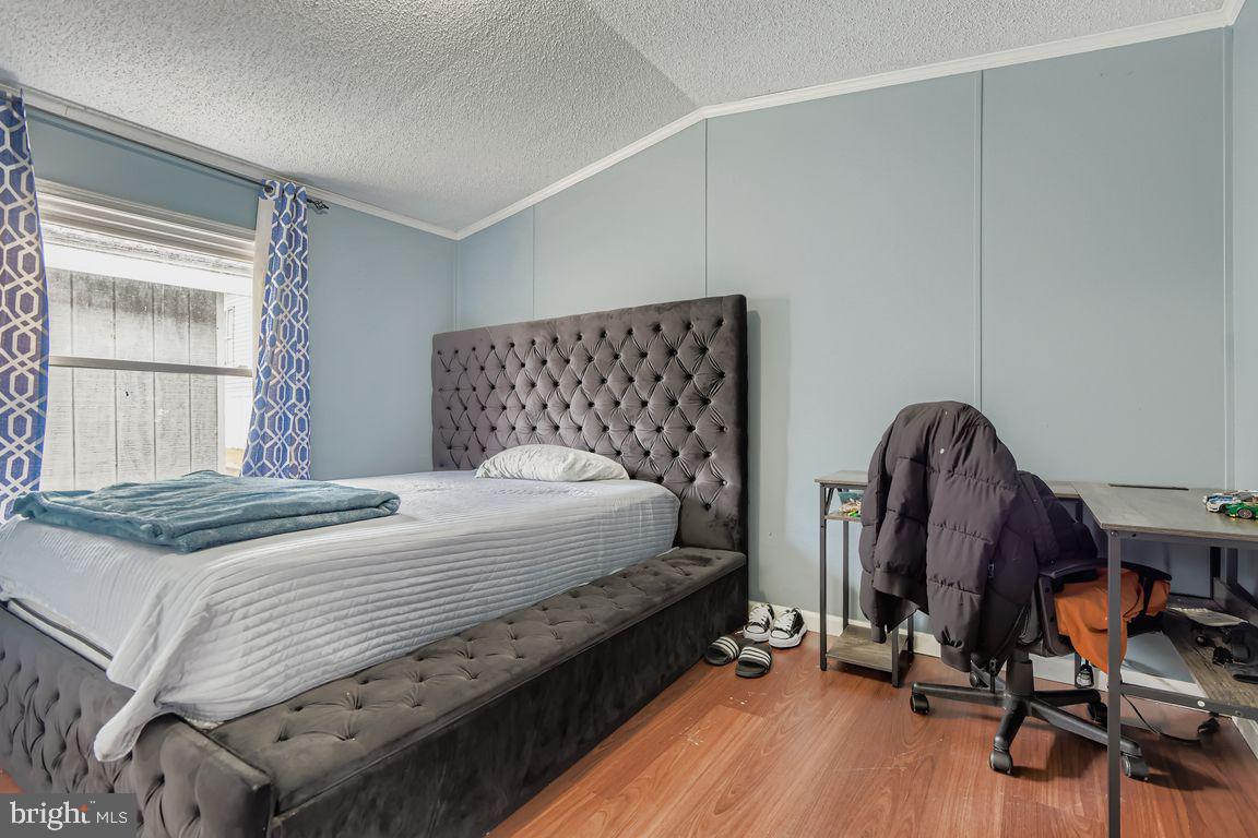 7810 Clark Road, Unit D64 Jessup, MD 20794 - Photo 18 of 28 a bedroom with a bed and a dresser