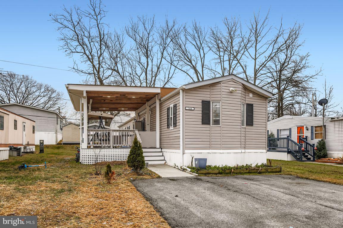 7810 Clark Road, Unit D64 Jessup, MD 20794 - Photo 2 of 28 a front view of a house with a yard