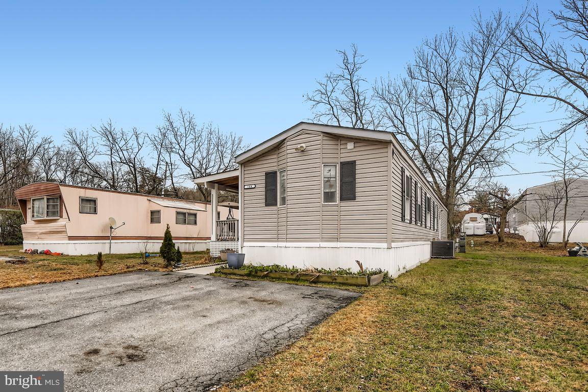 7810 Clark Road, Unit D64 Jessup, MD 20794 - Photo 3 of 28 a front view of a house with a yard