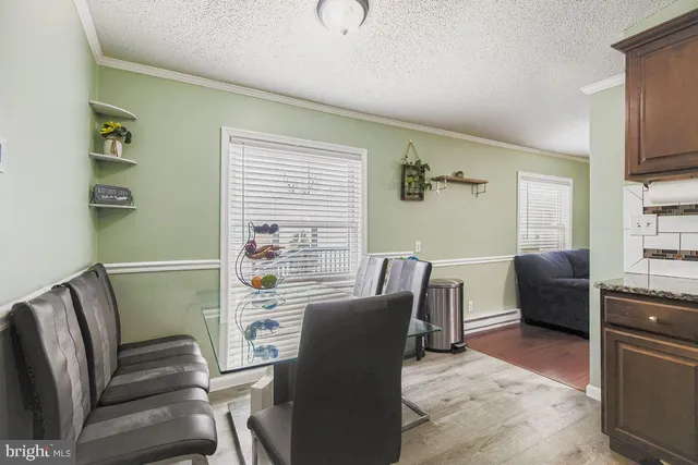 a view of a livingroom with furniture window and wooden floor