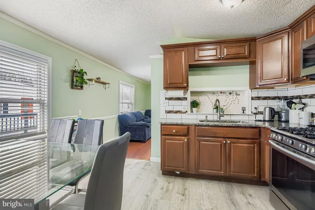 a kitchen with stainless steel appliances granite countertop a sink and cabinets