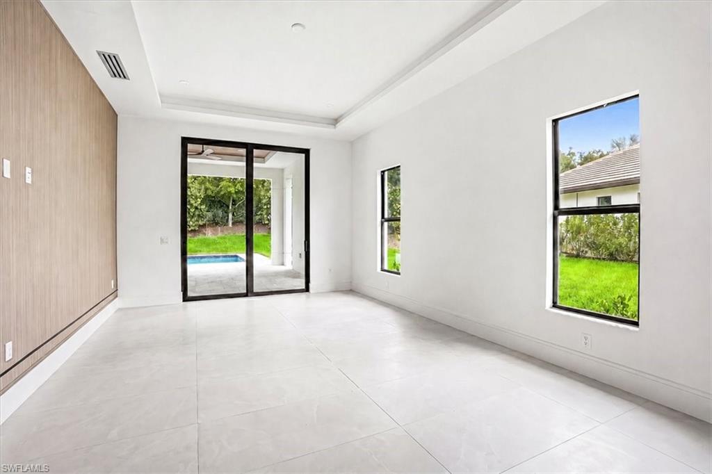 14318 Charthouse Circle Naples, FL 34114 - Photo 8 of 36 an empty room with windows