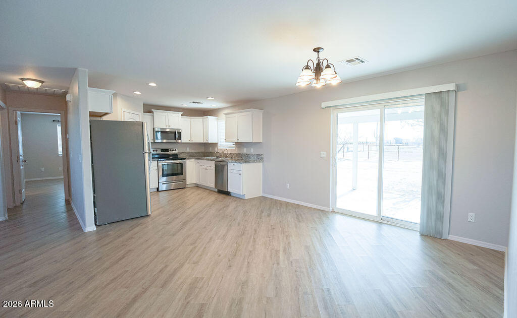 19643 East Rojo Road Florence, AZ 85132 - Photo 20 of 45 a view of a kitchen with refrigerator and wooden floor