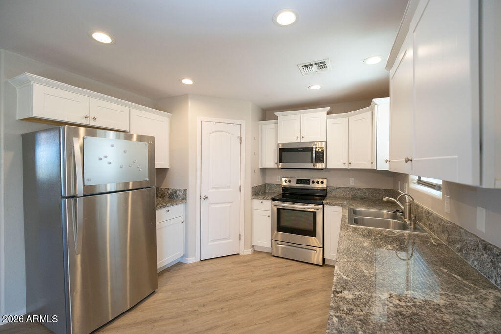 19643 East Rojo Road Florence, AZ 85132 - Photo 22 of 45 a kitchen with granite countertop a refrigerator and a sink