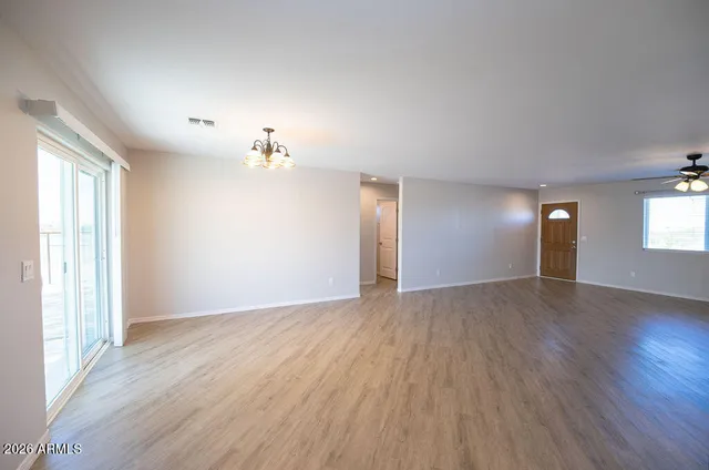 a view of an empty room with a ceiling fan
