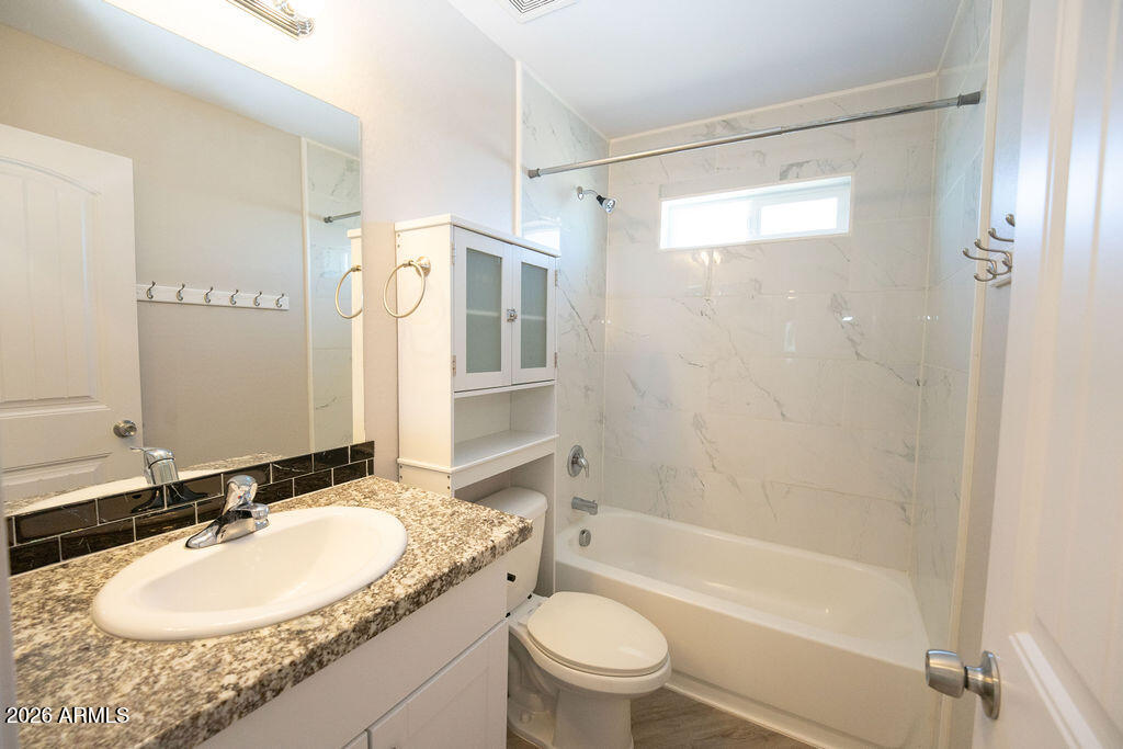 19643 East Rojo Road Florence, AZ 85132 - Photo 26 of 45 a bathroom with a granite countertop sink toilet mirror and shower