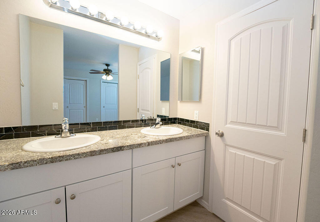 19643 East Rojo Road Florence, AZ 85132 - Photo 34 of 45 a bathroom with a granite countertop sink and a mirror