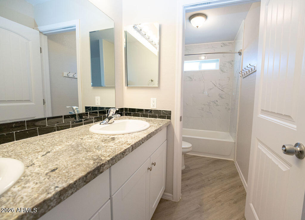 19643 East Rojo Road Florence, AZ 85132 - Photo 35 of 45 a bathroom with a granite countertop sink and a mirror