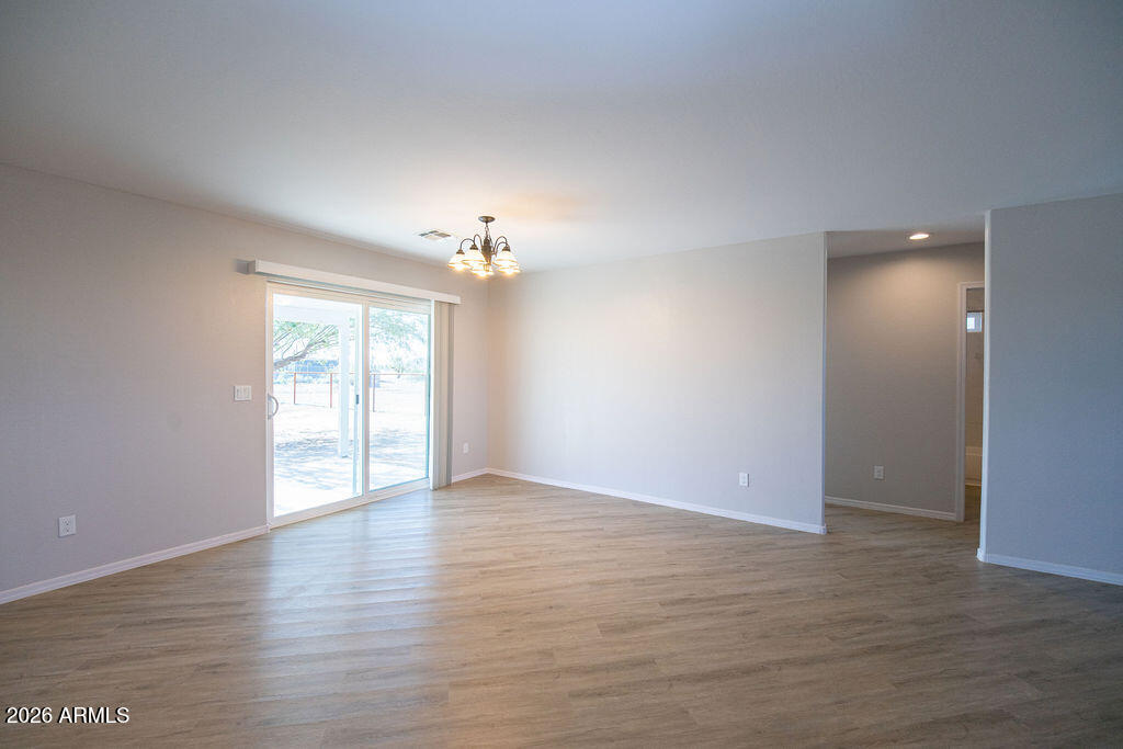 19643 East Rojo Road Florence, AZ 85132 - Photo 40 of 45 a view of an empty room with wooden floor and a window
