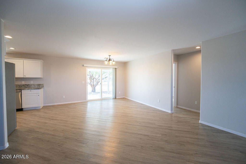 19643 East Rojo Road Florence, AZ 85132 - Photo 41 of 45 a view of an empty room with window and wooden floor