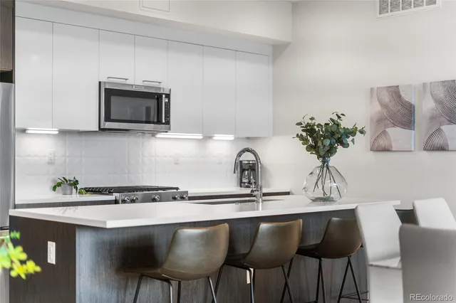 a kitchen with a table and chairs in it