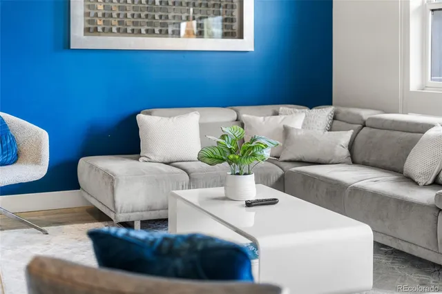 a living room with furniture flowerpot and window