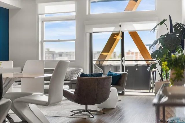 a living room with a large window and furniture