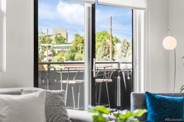 a living room with furniture and a floor to ceiling window