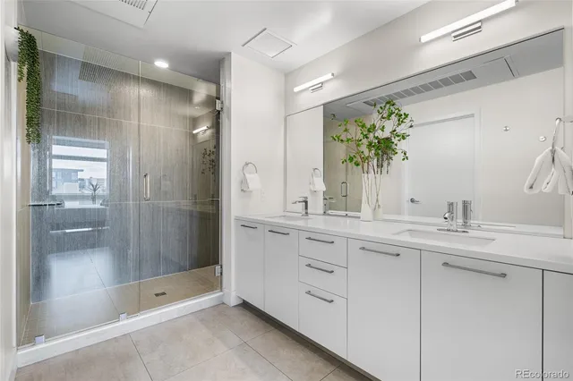 a bathroom with a shower sink and mirror