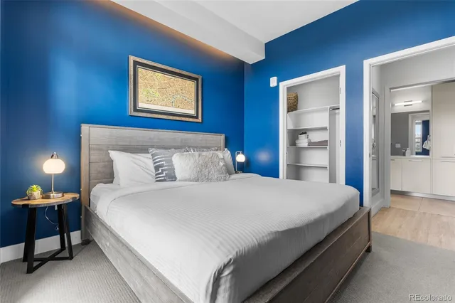 a bedroom with a bed and a lamp