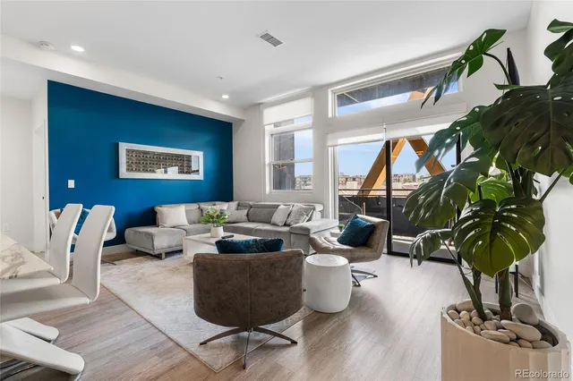 a living room with furniture potted plant and a window
