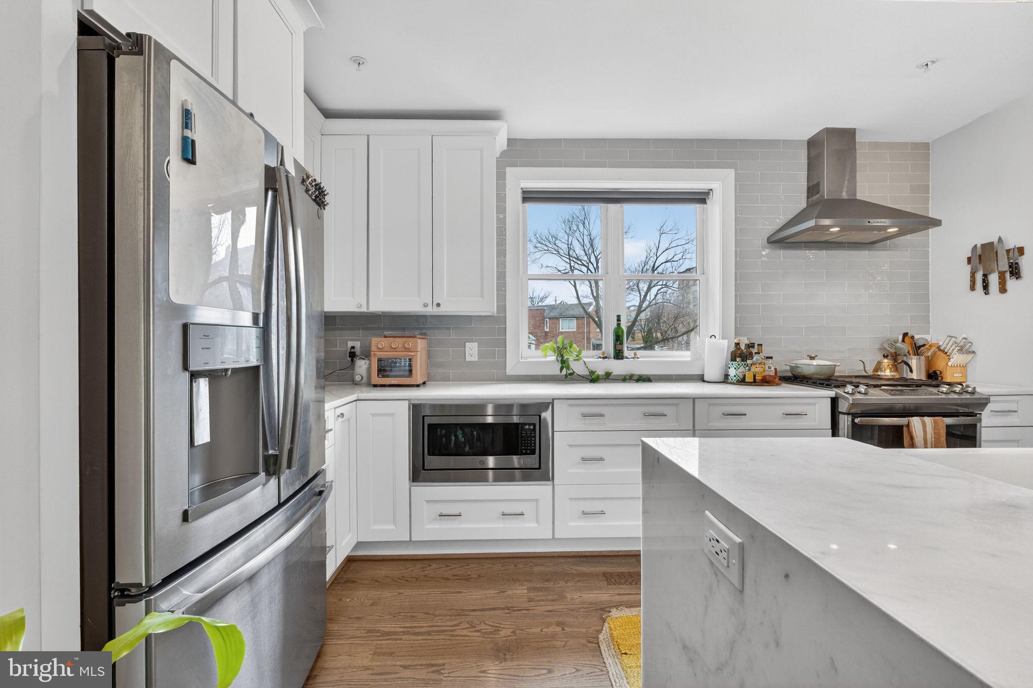 1419 Upshur Street Northwest, Unit 2 Washington, DC 20011 - Photo 12 of 47 a kitchen with stainless steel appliances a stove a sink and a refrigerator
