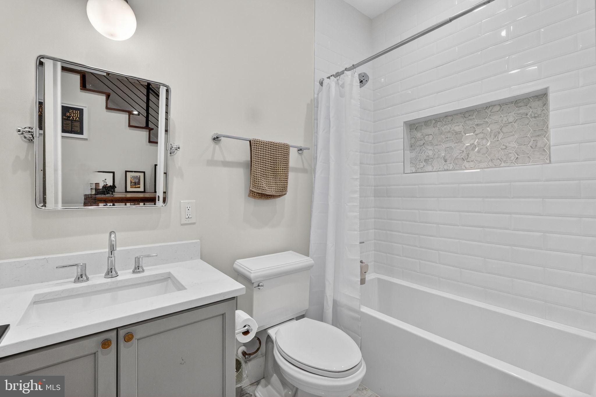 1419 Upshur Street Northwest, Unit 2 Washington, DC 20011 - Photo 15 of 47 a bathroom with a sink a toilet and shower