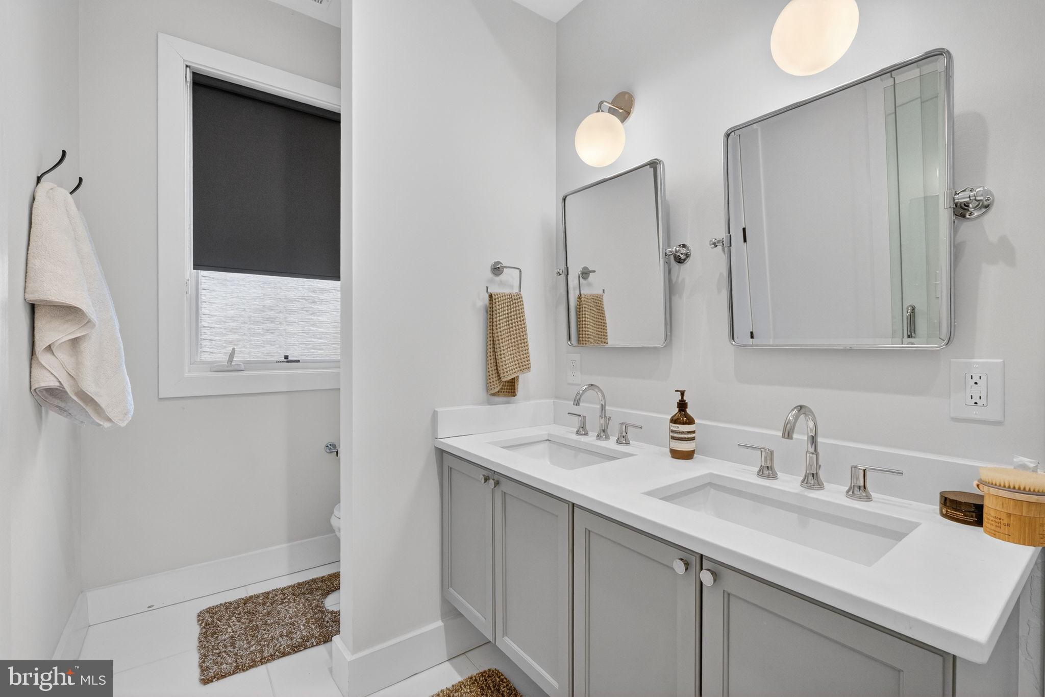 1419 Upshur Street Northwest, Unit 2 Washington, DC 20011 - Photo 20 of 47 a bathroom with a sink a mirror and a shower