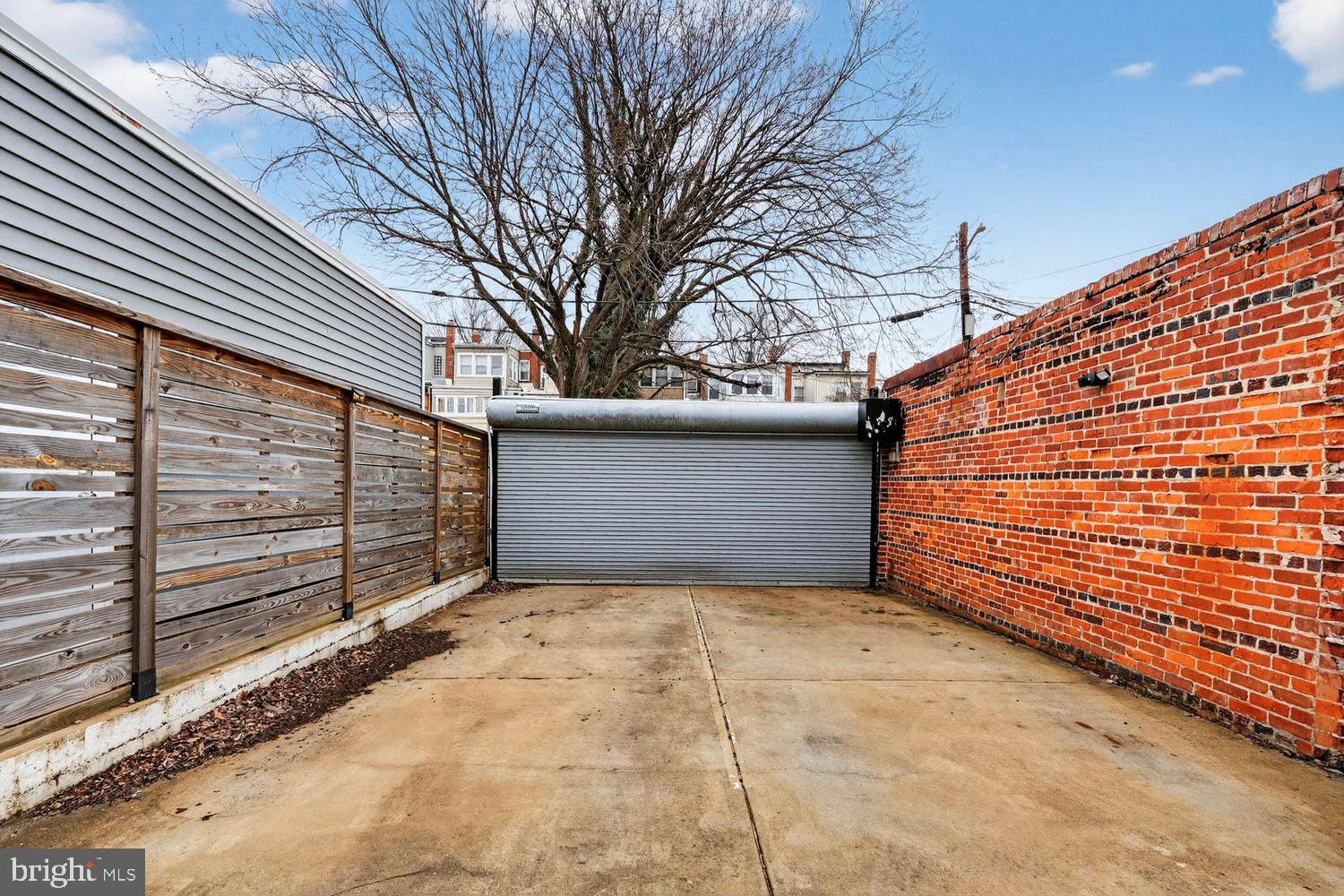 1419 Upshur Street Northwest, Unit 2 Washington, DC 20011 - Photo 36 of 47 a view of a backyard with a fence and trees