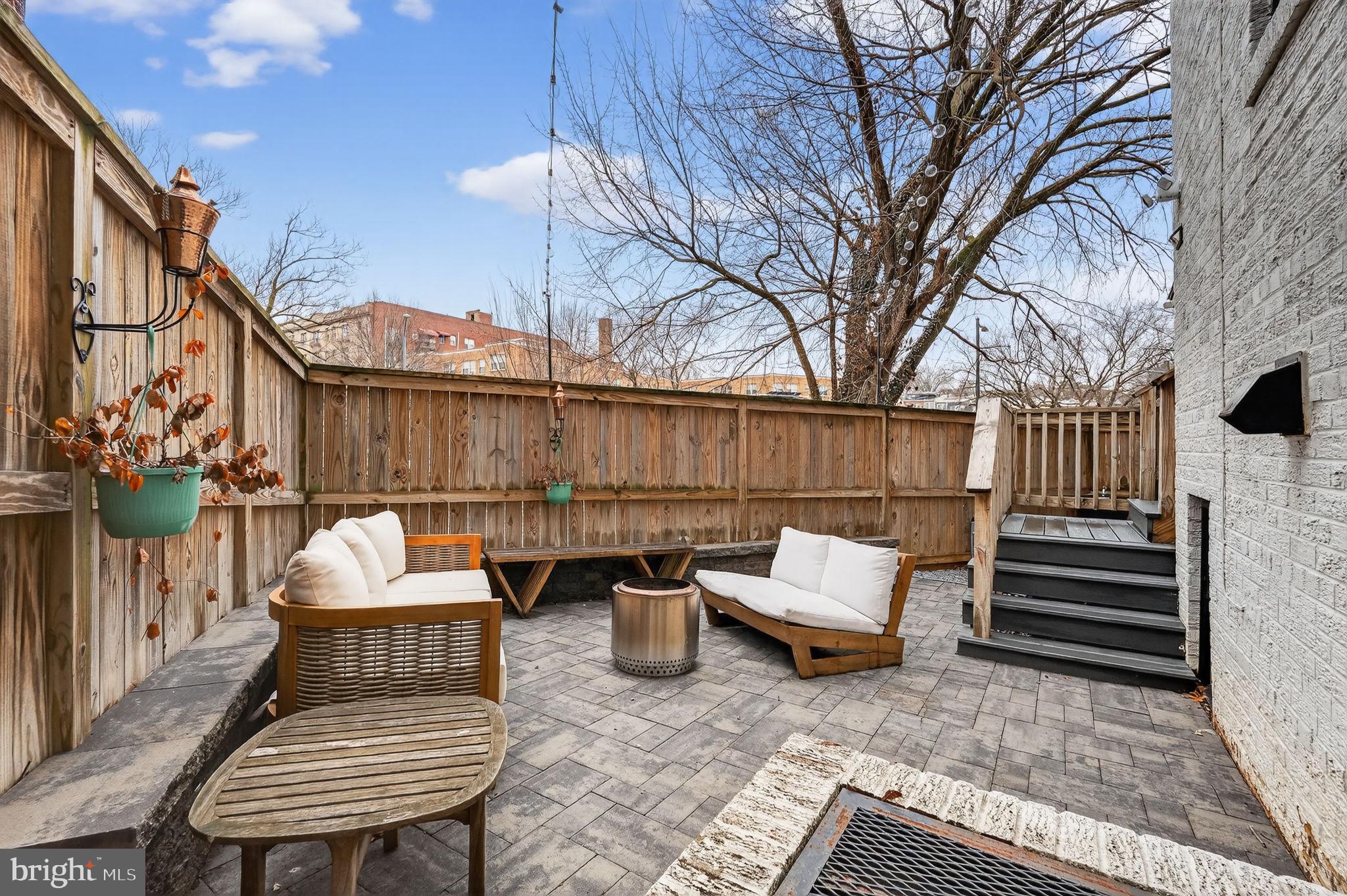 1419 Upshur Street Northwest, Unit 2 Washington, DC 20011 - Photo 40 of 47 a backyard of a house with a table and chairs