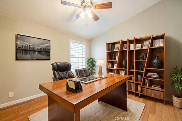 a view of a workspace with furniture and wooden floor