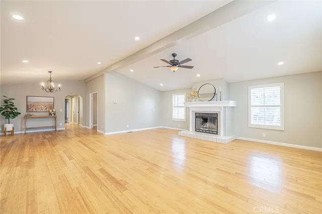 a view of an empty room with a fireplace and a window