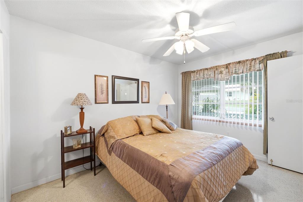 1830 South Mandarin Terrace Inverness, FL 34450 - Photo 44 of 47 a bedroom with a large bed and a chandelier