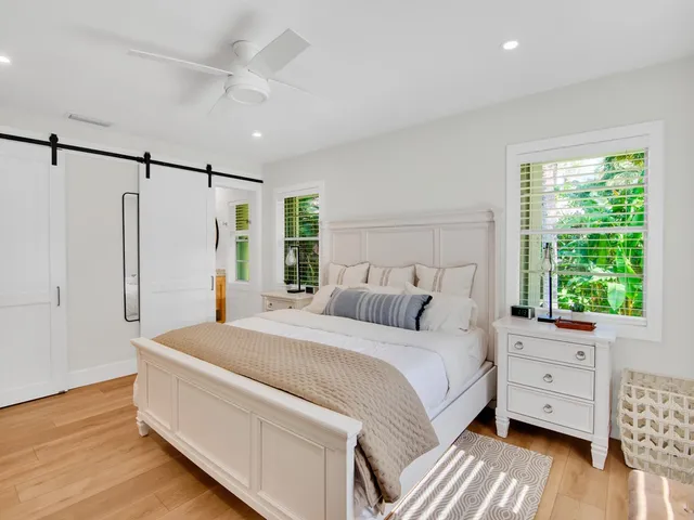 a room with a bed dresser and a window