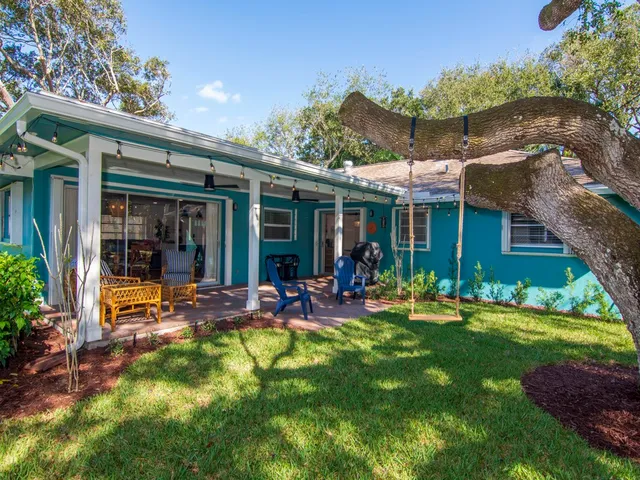 a front view of house with a garden and patio