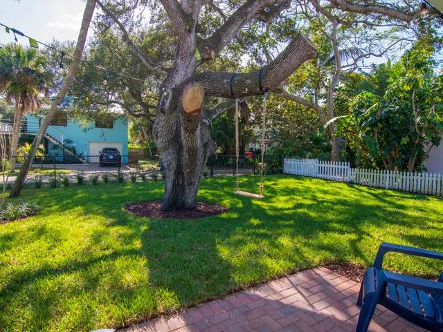 a view of a backyard with swimming pool