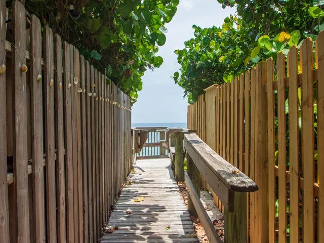 a view of a balcony with wooden floor and fence