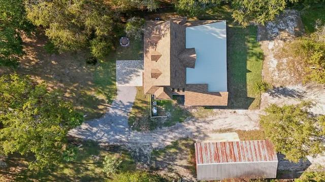 an aerial view of a house with a yard