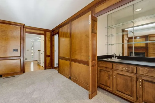 a kitchen with kitchen island a counter top space a sink stainless steel appliances and cabinets