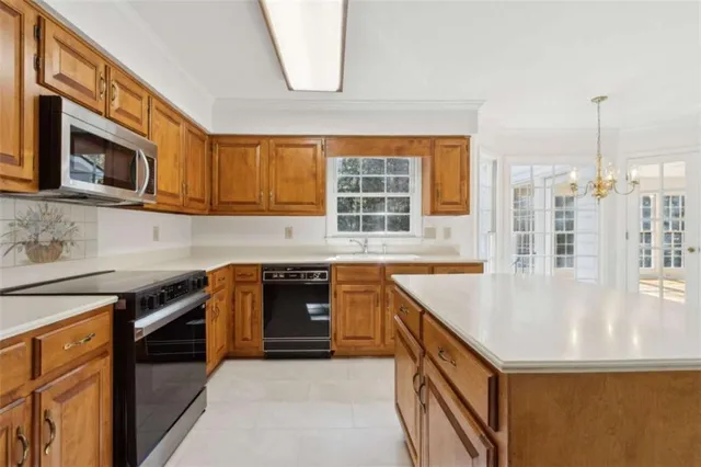 an empty room with ceiling fan and window