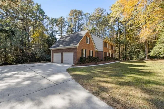 a view of staircase with lots of frames on wall and wooden floor