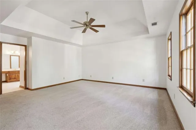 an empty room with windows and closet