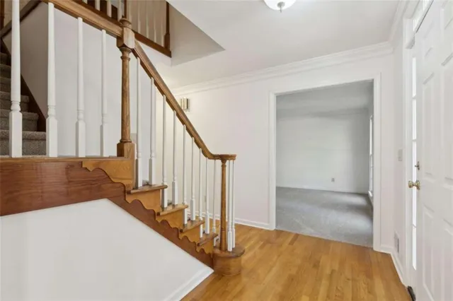 a view of an empty room with a fireplace and a window