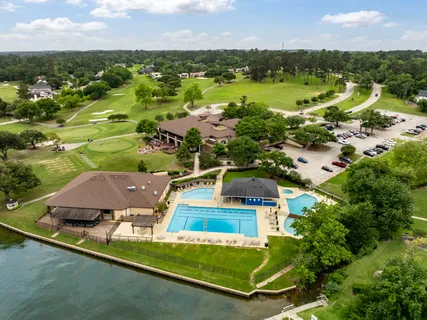 an aerial view of residential houses with outdoor space and river