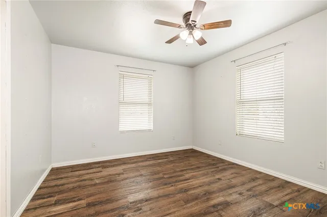 wooden floor in an empty room with a window