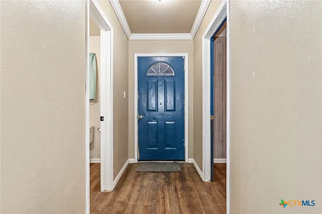 a view of a hallway with wooden floor