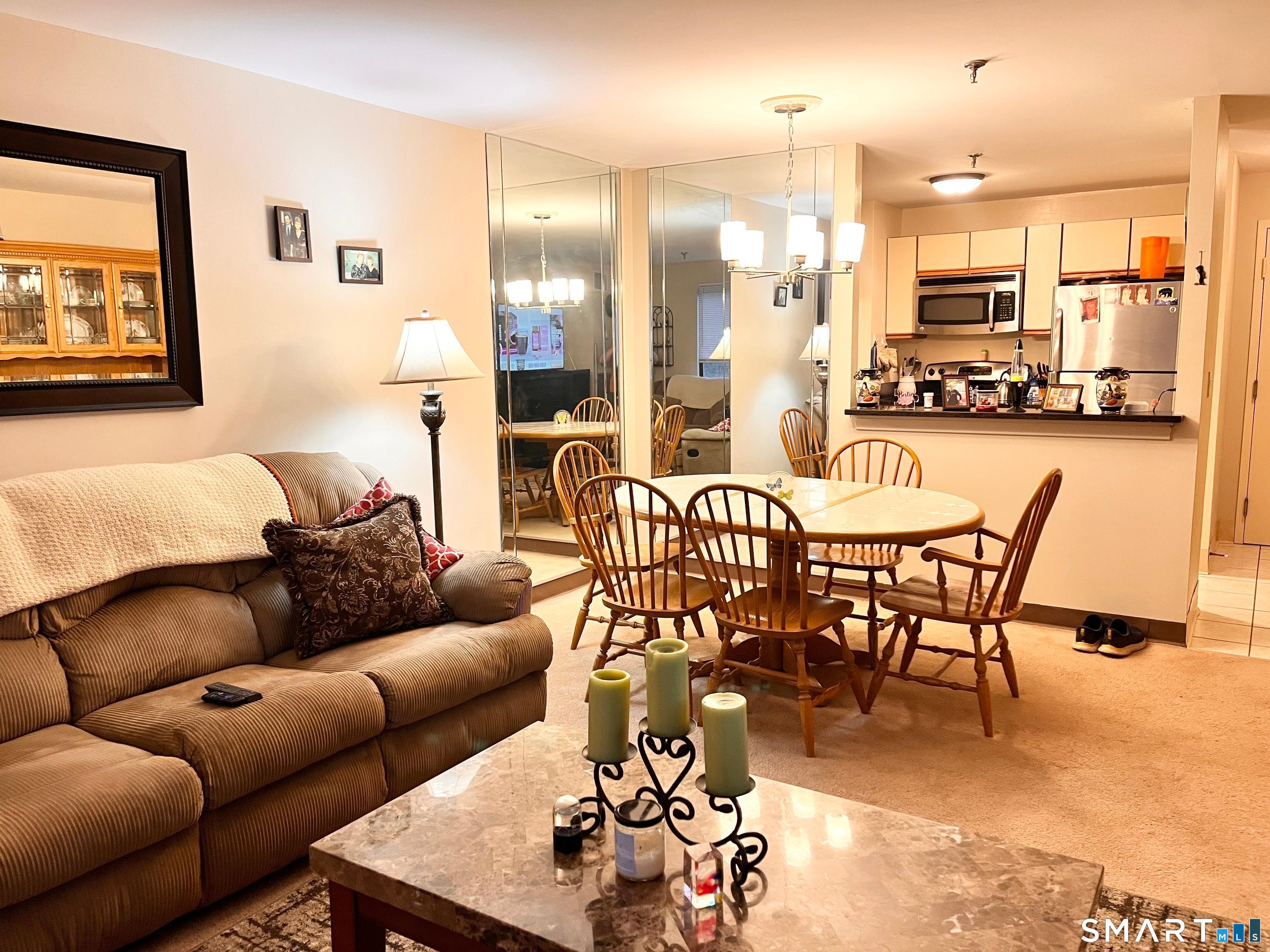 96 Putter Drive, Unit 510N Wallingford, CT 06492 - Photo 13 of 23 a living room with furniture kitchen view and a large window